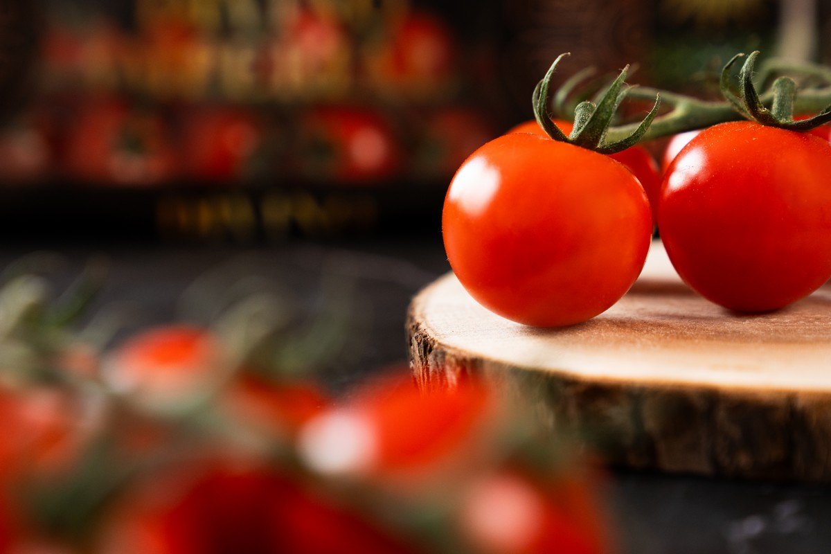 Tomate cherry en rama de Cualin Quality junto al envase de Divino Imperial